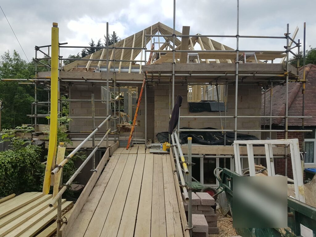 New first-floor walls and roof trusses going up