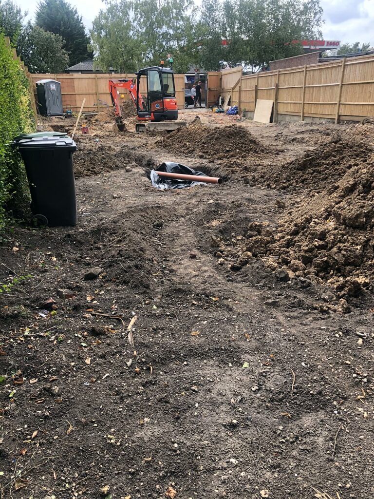 Project story: from old bungalow to two new family homes in Eastleigh The plot cleared, with the digger ready for groundworks