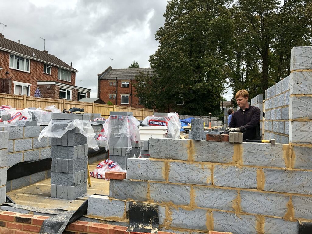Project story: from old bungalow to two new family homes in Eastleigh Our team building up the blockwork walls
