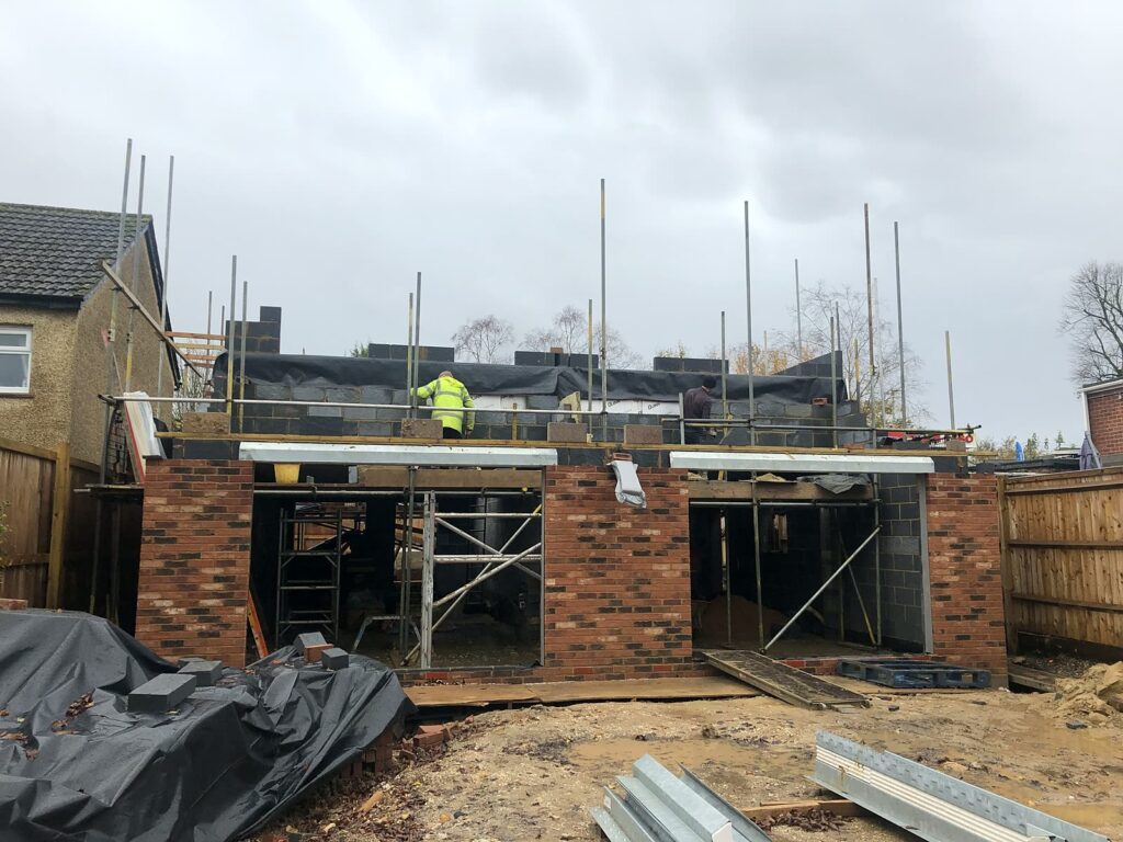 Project story: from old bungalow to two new family homes in Eastleigh Scaffolding up and the first floor under way
