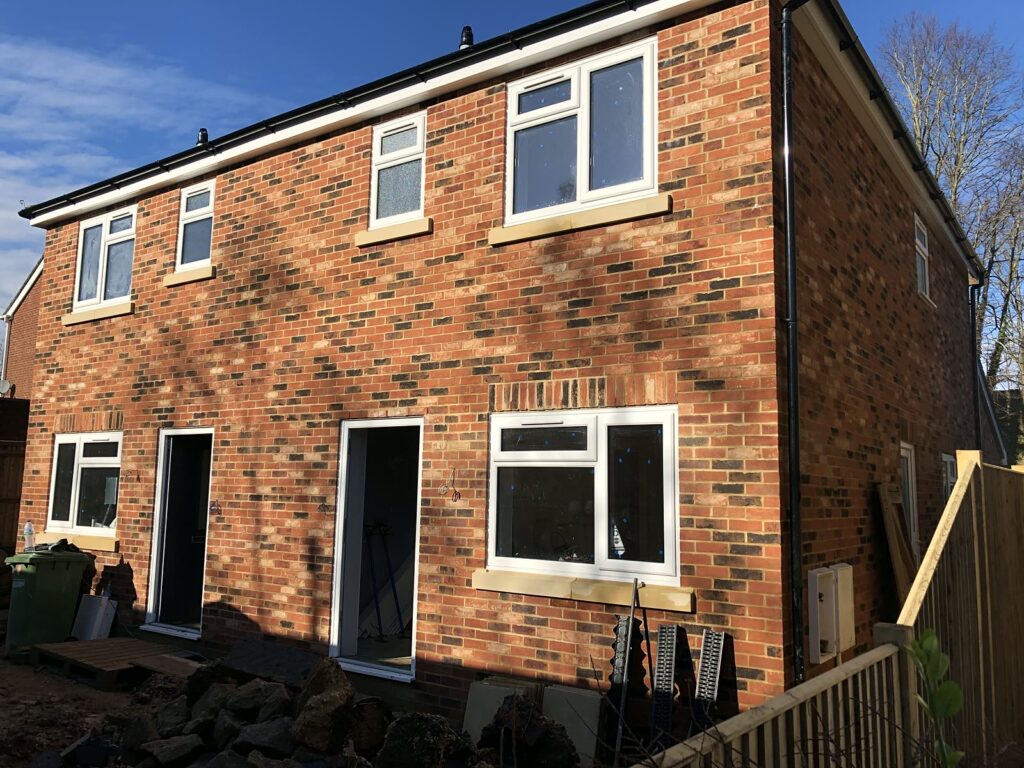 Project story: from old bungalow to two new family homes in Eastleigh The two new homes taking shape, with the windows in