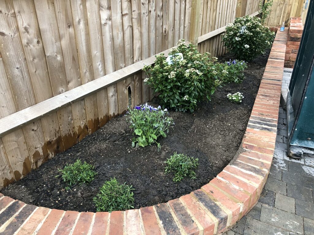 Project story: from old bungalow to two new family homes in Eastleigh A new planted front garden with a curved brick wall