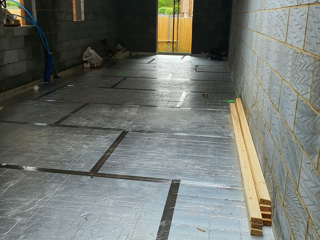 Project story: four new flats in Hampshire, from groundworks to handover Floor insulation laid and taped across a ground-floor flat
