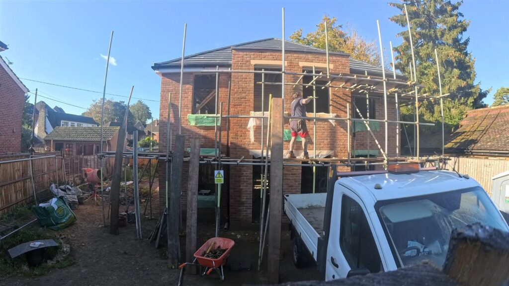 Project story: four new flats in Hampshire, from groundworks to handover The roof on, with scaffolding still up