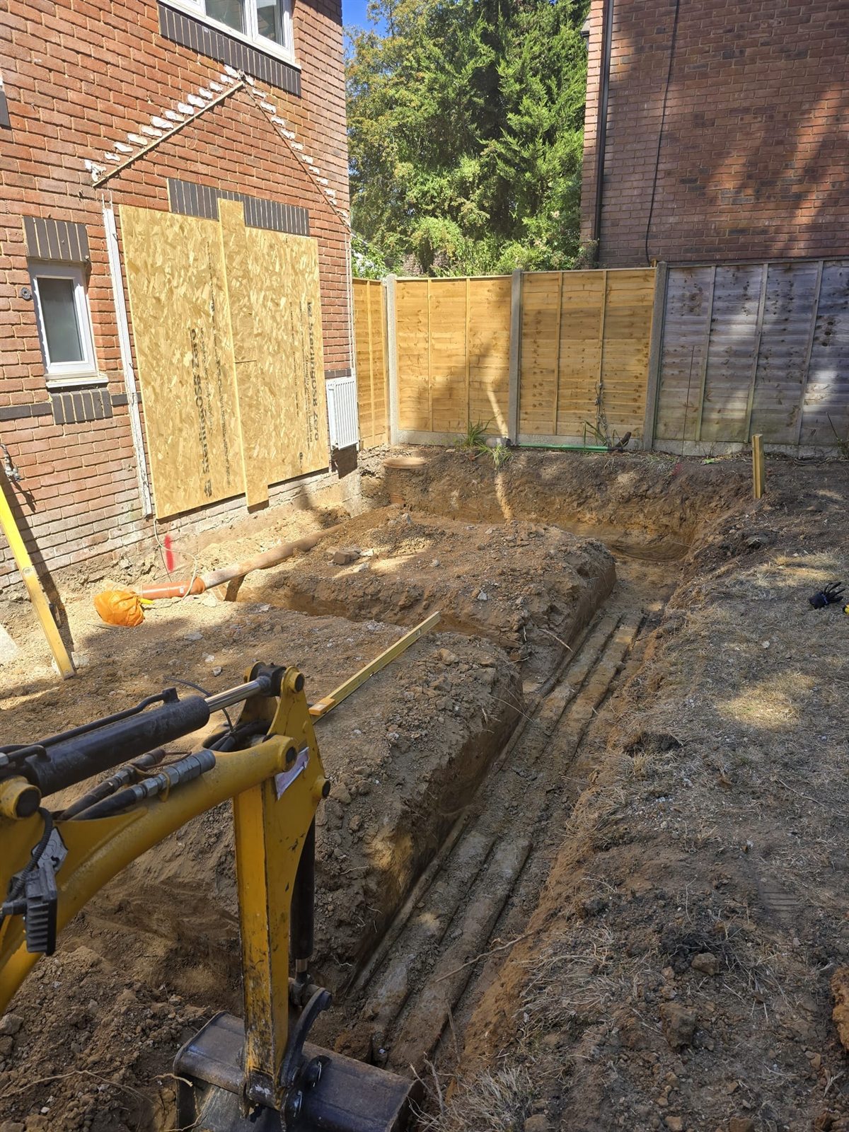 Digger working on the foundation trench for a rear extension